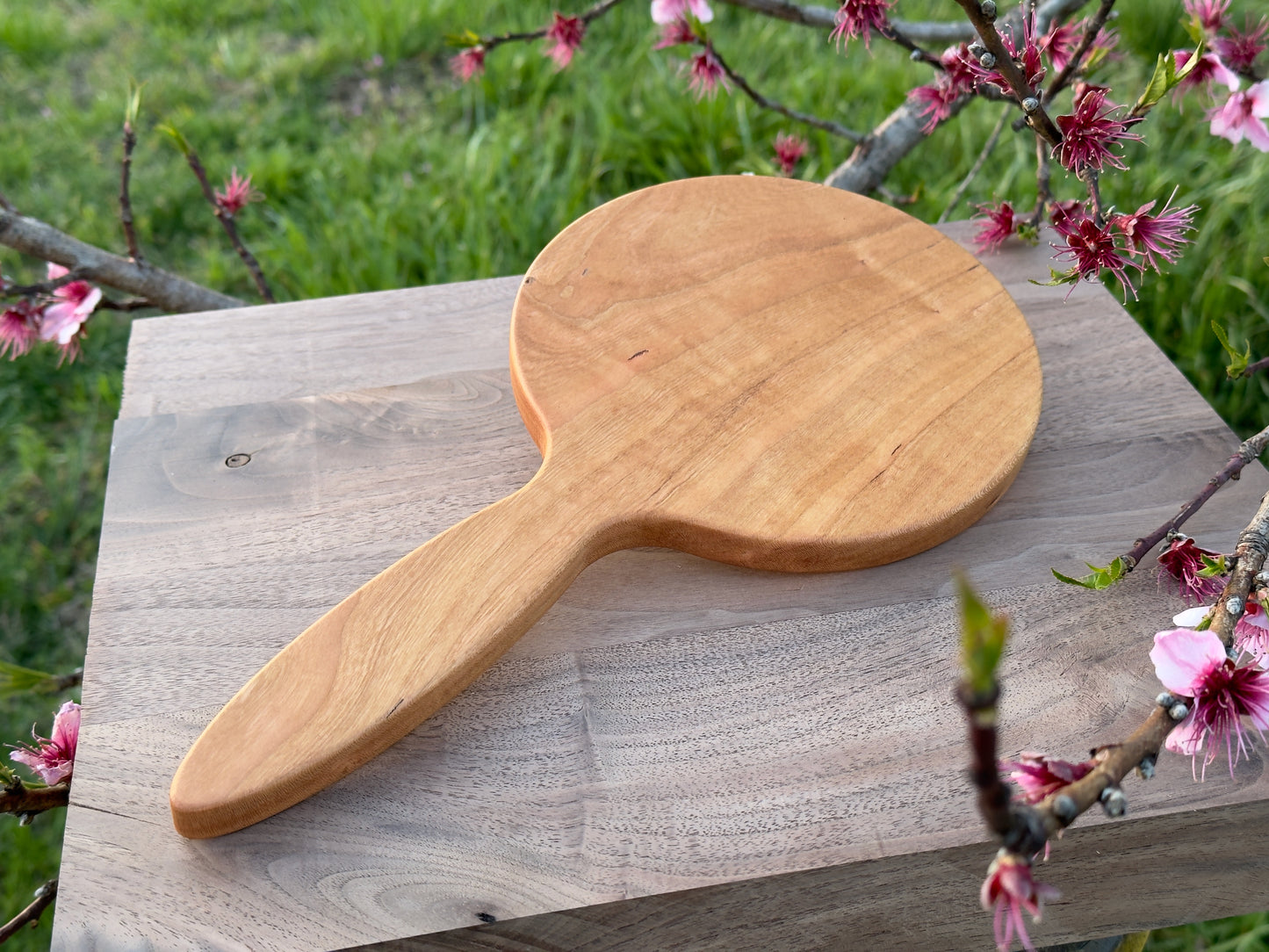 Wood hand mirror made from solid cherry hardwood. Back view shown featuring a 6 inch beveled glass mirror.