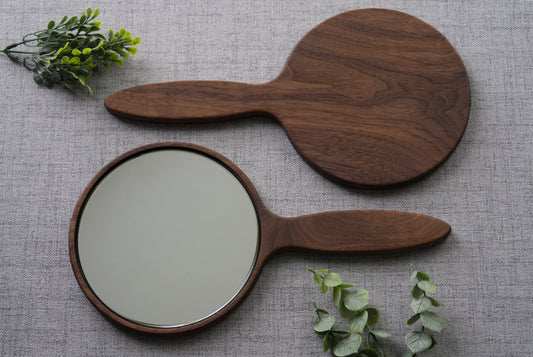 Wood hand mirror made from solid black walnut hardwood. Front and back view shown featuring a 6 inch beveled glass mirror.
