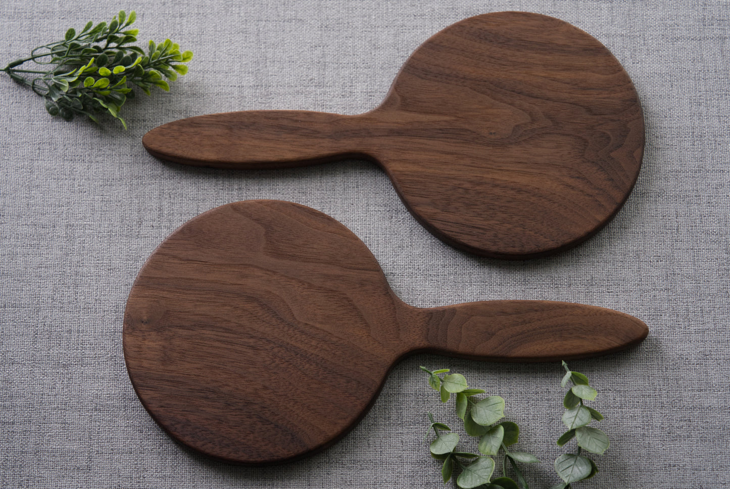 Wood hand mirror made from solid black walnut hardwood. back view shown featuring a 6 inch beveled glass mirror.