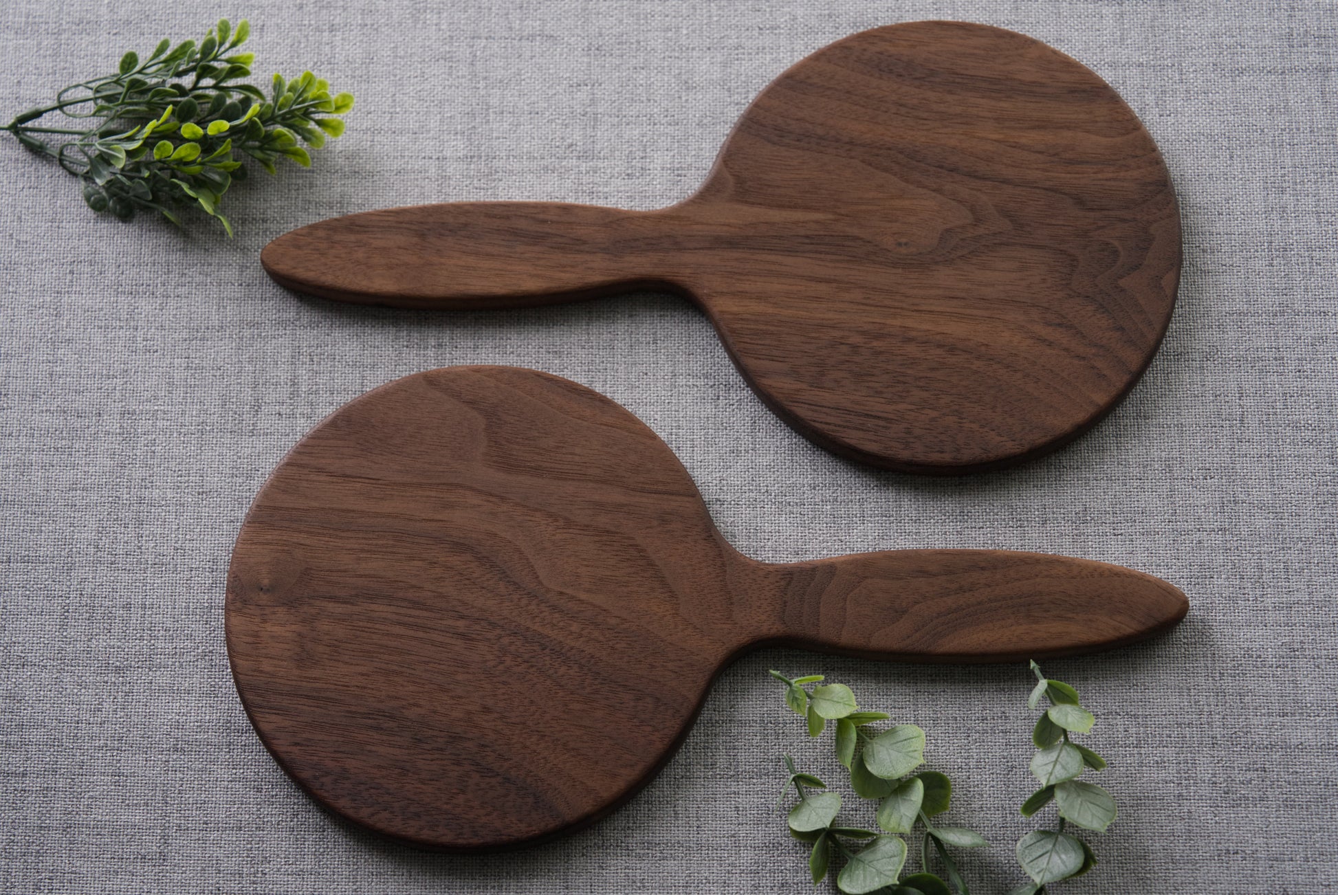 Wood hand mirror made from solid black walnut hardwood. back view shown featuring a 6 inch beveled glass mirror.